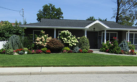 Long Island Landscape Designers - Exterior front view of a landscaped home.